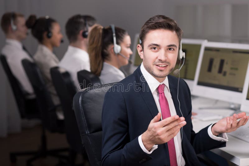 Shot of a young hotline consultant solving his client's problem. Shot of a young hotline consultant solving his client's problem