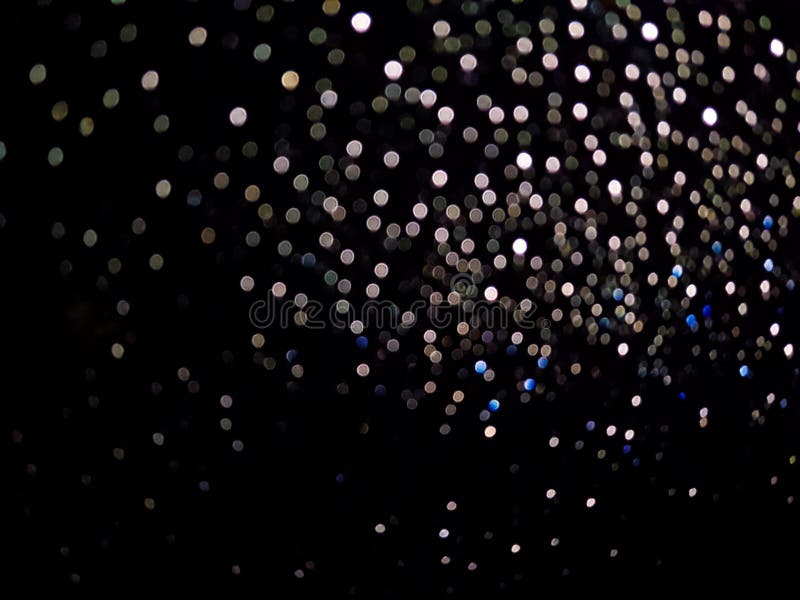 A small bokeh caused by the light hits the raindrop. A small bokeh caused by the light hits the raindrop.