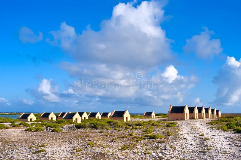 Bonaire landscape showing small stone cottages that once housed the slaves that raked the salt and loaded the offlying ships. Bonaire landscape showing small stone cottages that once housed the slaves that raked the salt and loaded the offlying ships.