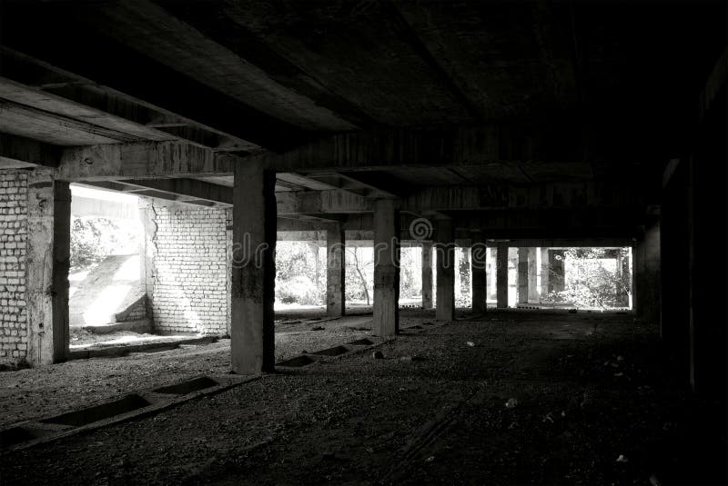 Unfinished and abandoned concrete and brick building. Unfinished construction with harsh sun light and shades. Unfinished and abandoned concrete and brick building. Unfinished construction with harsh sun light and shades.