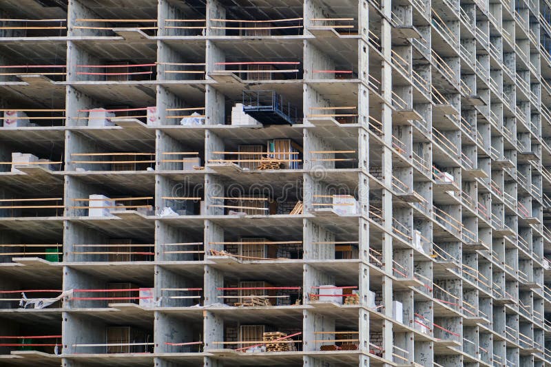 Unfinished floors of a multi-storey building without external walls. Exterior of a house with empty unfinished apartments, background. Unfinished floors of a multi-storey building without external walls. Exterior of a house with empty unfinished apartments, background.