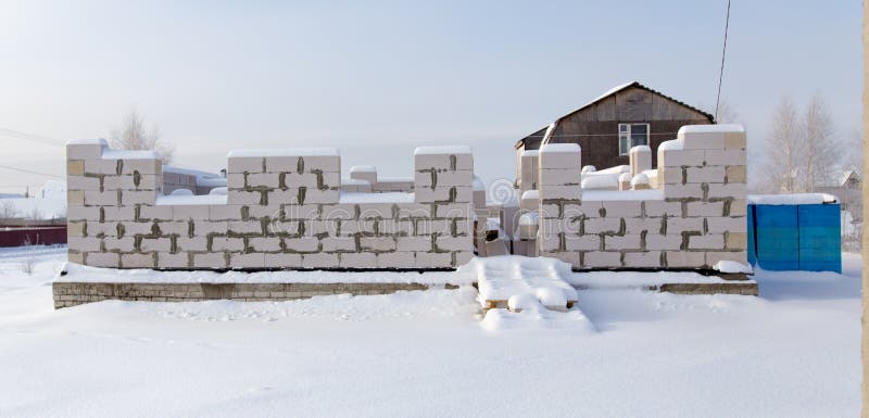 Unfinished house in the winter in the village . Unfinished house in the winter in the village .