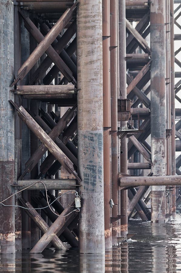 Rusty iron supports of an unfinished bridge close-up. Rusty iron supports of an unfinished bridge close-up