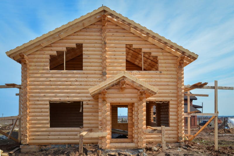 Unfinished, ecological wooden house from beams in countryside. Unfinished, ecological wooden house from beams in countryside.