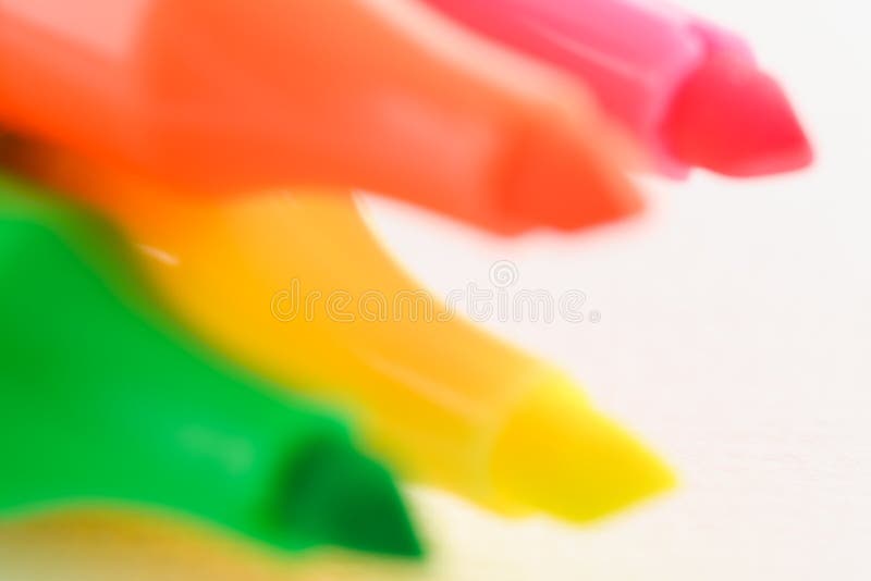 Blurred tips of four different neon colored felt tip pens, used for marking text elements out of one production line series. Blurred tips of four different neon colored felt tip pens, used for marking text elements out of one production line series