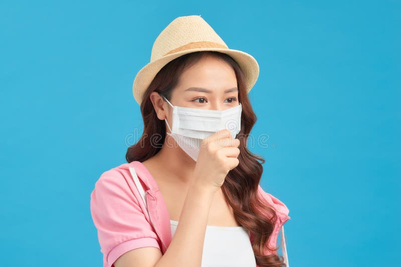 Dissatisfied woman in hat protects face with mask, thinks abot risk of epidemic disease, has virus infection. Dissatisfied woman in hat protects face with mask, thinks abot risk of epidemic disease, has virus infection.