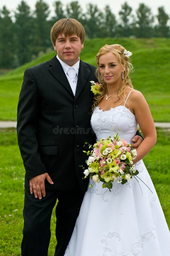 Newlywed couple posing in countryside. Newlywed couple posing in countryside.