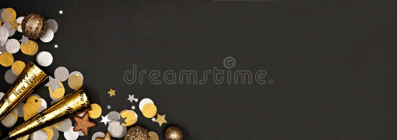 New Years Eve corner border banner of confetti, decorations and noisemakers. Overhead view on a black background. New Years Eve corner border banner of confetti, decorations and noisemakers. Overhead view on a black background