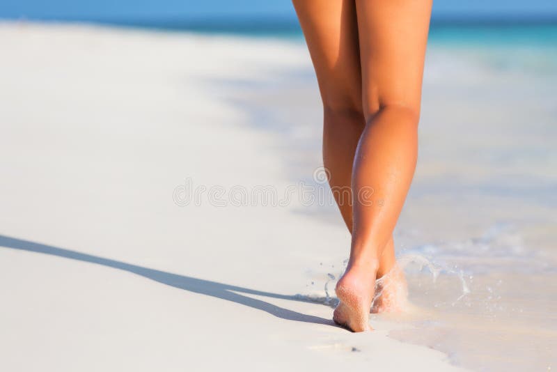 Woman legs walking on the beach sand. Woman legs walking on the beach sand