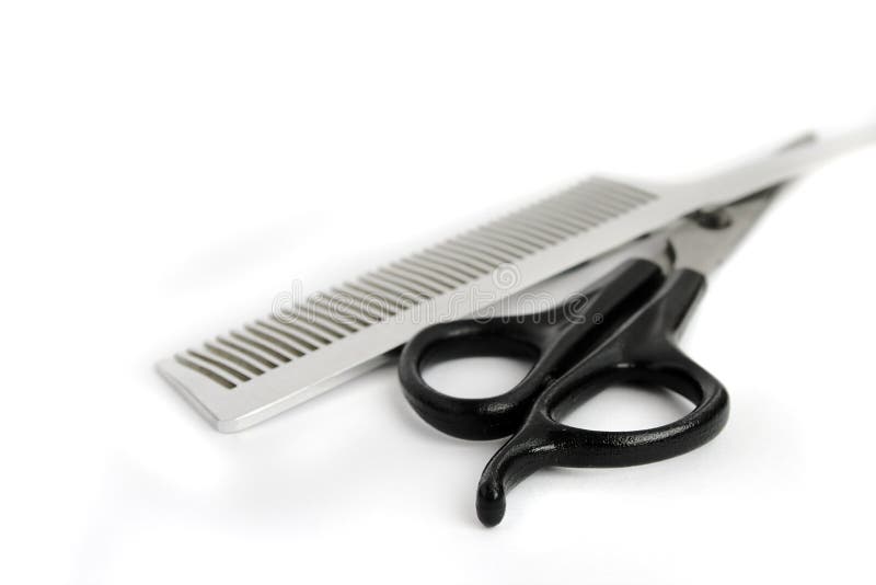 Scissors and hairbrush on the white. Scissors and hairbrush on the white