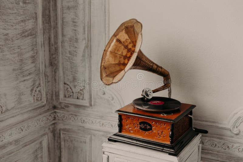 Music device. Old gramophone with plate or vinyl disk on wooden box. Antique brass record player. Gramophone with horn speaker. Retro entertainment concept. Music device. Old gramophone with plate or vinyl disk on wooden box. Antique brass record player. Gramophone with horn speaker. Retro entertainment concept.