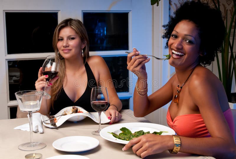 2 Young girls having dinner in a restaurant. 2 Young girls having dinner in a restaurant.