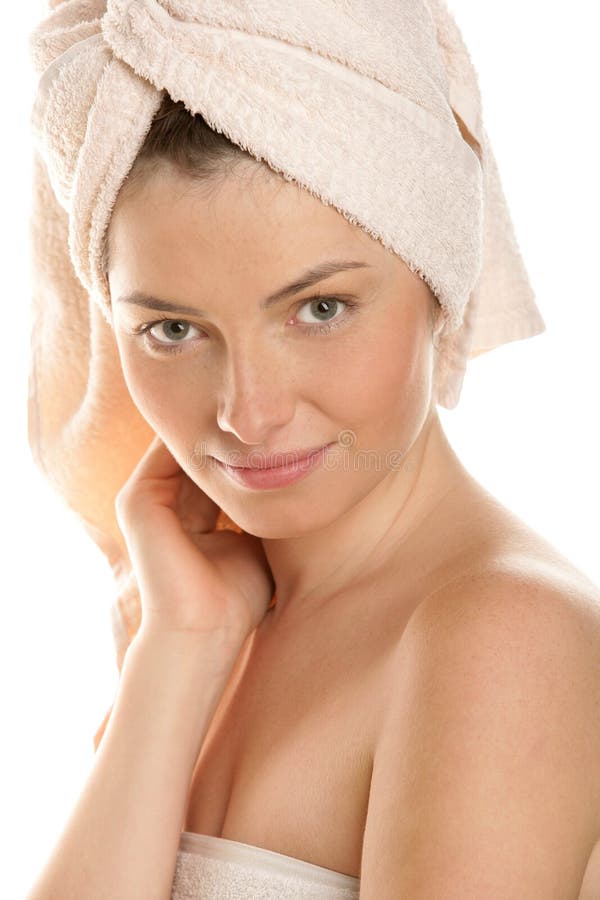 Portrait of young woman with head wrapped towel isolated on white background. Portrait of young woman with head wrapped towel isolated on white background