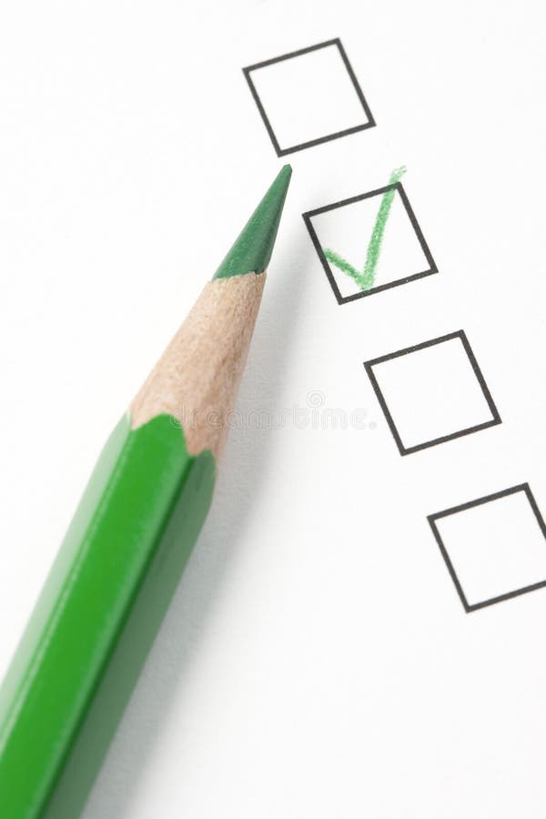 Green check box on survey box with green pencil. Focus on tip of pencil. Green check box on survey box with green pencil. Focus on tip of pencil