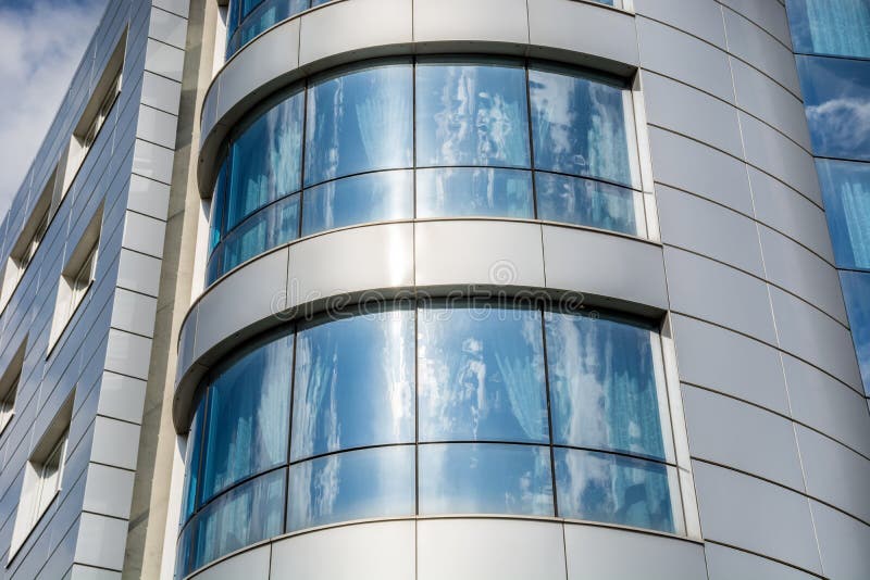 Облака и небо отразили в окнах на современном офисном здании стоковое фото rf Облака и небо отразили в окнах на современном офисном здании стоковое фото rf