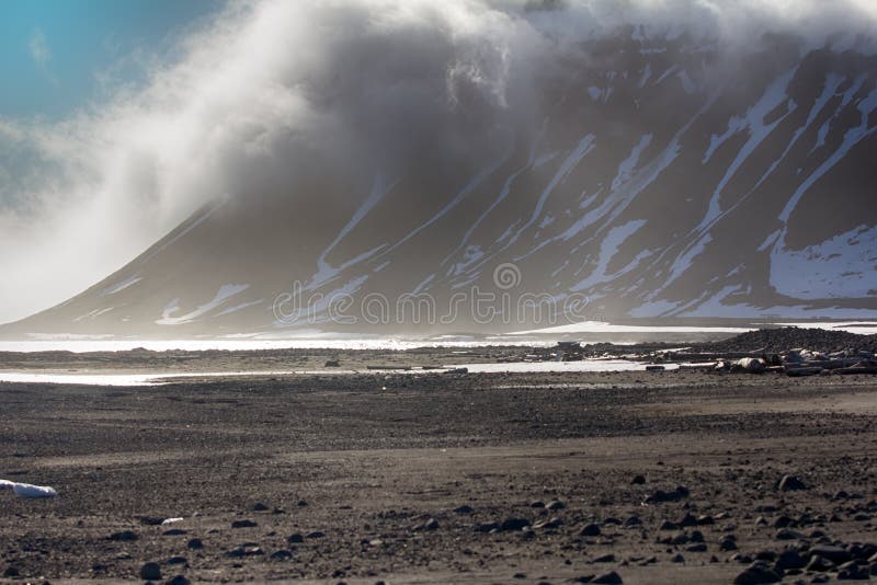 Gloomy Cover glacier in Arctic Franz-Josef Land . Cloud caught on the glacial sheet, nunatak in fog. Gloomy Cover glacier in Arctic Franz-Josef Land . Cloud caught on the glacial sheet, nunatak in fog