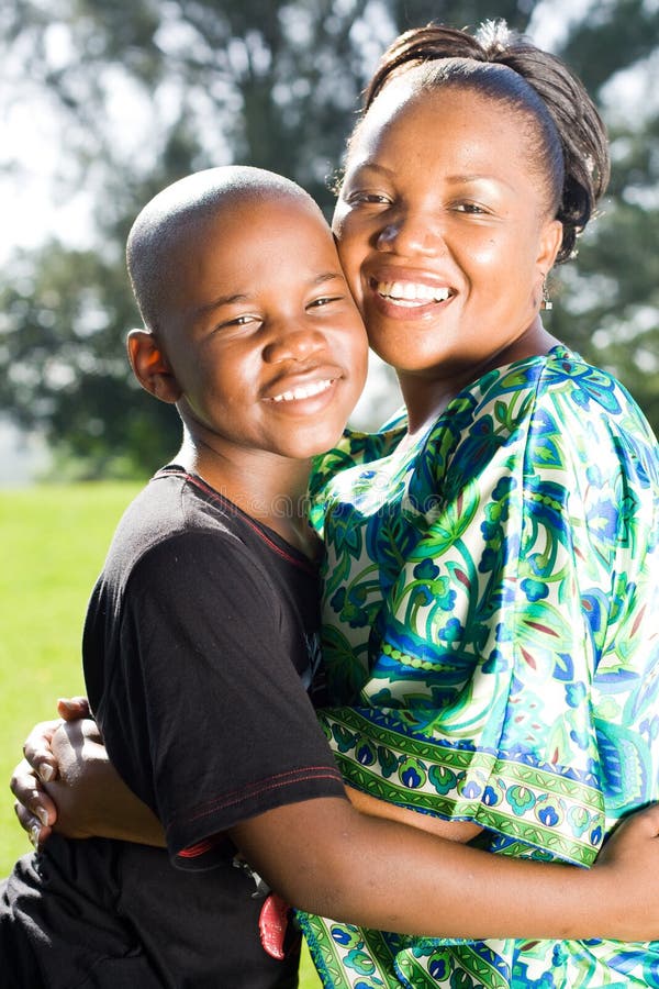 Happy african mother hugging teen son. Happy african mother hugging teen son