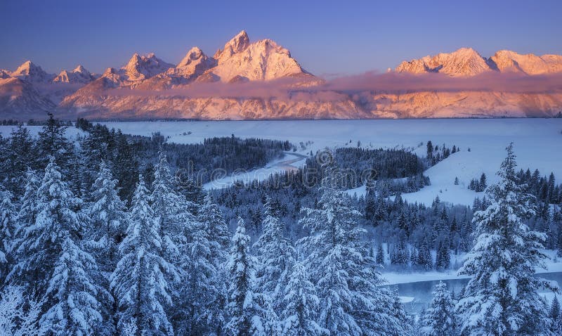 The winter sun rises over the Snake River and Teton Range in Grand Teton National Park, Wyoming. The winter sun rises over the Snake River and Teton Range in Grand Teton National Park, Wyoming.