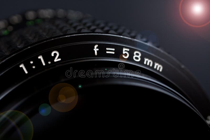 58mm 1.2 lens closeup with flare on black background. 58mm 1.2 lens closeup with flare on black background