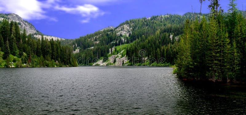 Scenic view of Boulder lake with forested mountains in background, Idaho, U.S.A. Scenic view of Boulder lake with forested mountains in background, Idaho, U.S.A.