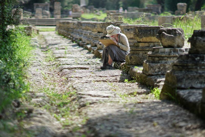 Olympia, Greece, 17 July 2018 Archaeologist at work under the sun at the archaeological site of Olympia. Olympia, Greece, 17 July 2018 Archaeologist at work under the sun at the archaeological site of Olympia