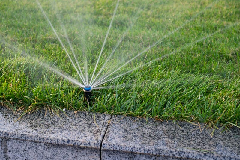 Installation modern garden irrigation system watering lawn. Installation modern garden irrigation system watering lawn