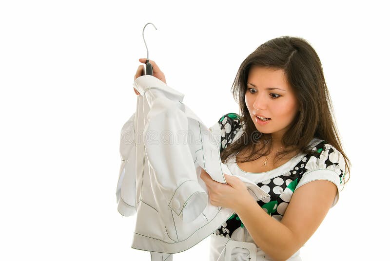 Young girl views white jacket on white background. Young girl views white jacket on white background