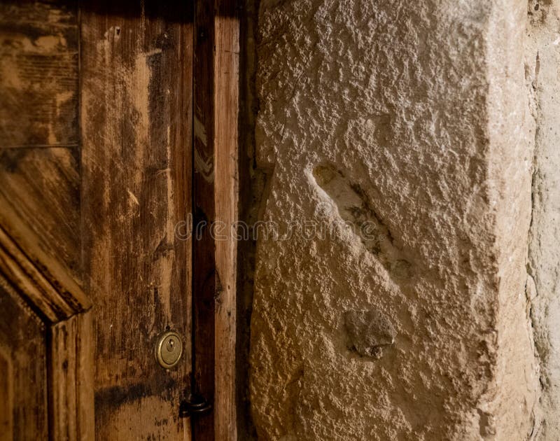 Hole carved into a stone door post where a Mezuzah small scroll containing a prayer was once placed, photographed in Kazimierz, the historic Jewish quarter of Krakow, Poland. Hole carved into a stone door post where a Mezuzah small scroll containing a prayer was once placed, photographed in Kazimierz, the historic Jewish quarter of Krakow, Poland.