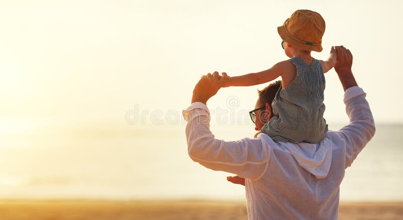 Father`s day. Dad and baby son playing together outdoors on a summer beach. Father`s day. Dad and baby son playing together outdoors on a summer beach