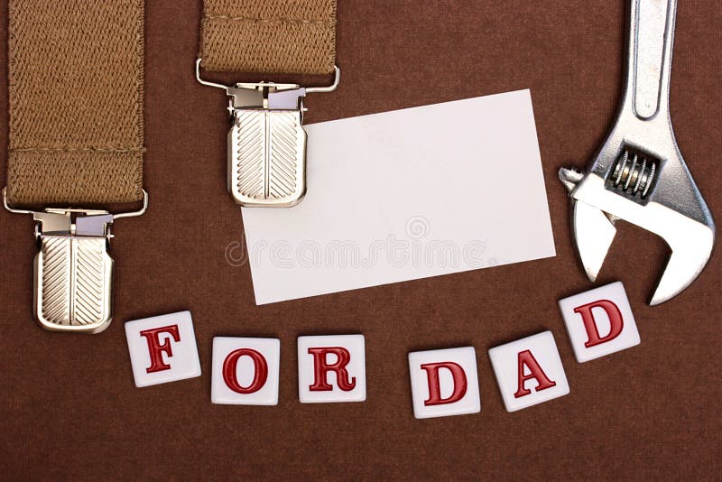 By a holiday day of the father man's braces, business a card, tool and inscription For Dad. By a holiday day of the father man's braces, business a card, tool and inscription For Dad.