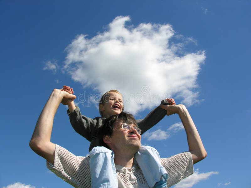 Father with son on shoulders sunny day cloud blue sky. Father with son on shoulders sunny day cloud blue sky