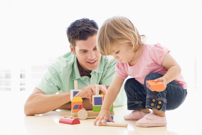 Father and daughter indoors playing and smiling. Father and daughter indoors playing and smiling