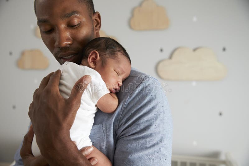 Father Holding Newborn Baby Son In Nursery. Father Holding Newborn Baby Son In Nursery