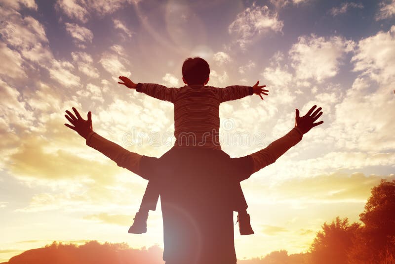 Family time father and son watch and praise the sunset. Family time father and son watch and praise the sunset