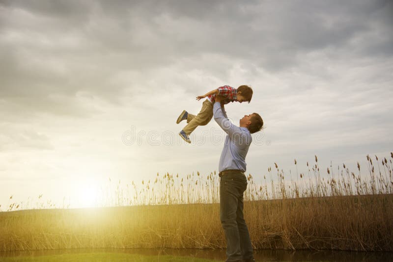 Father with son outdoors at sunset. Father with son outdoors at sunset