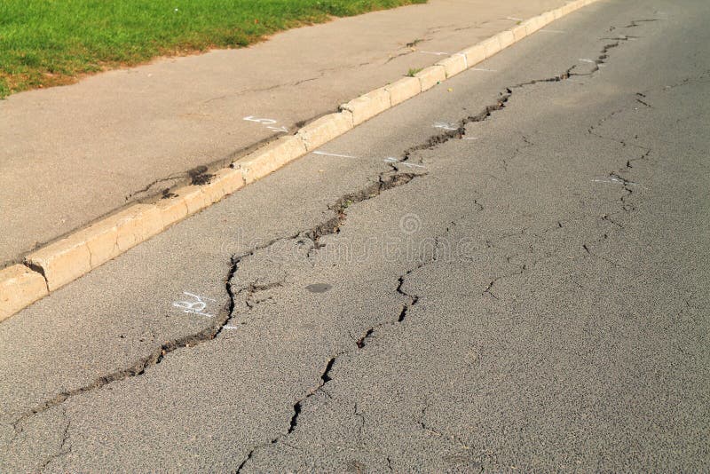 Cracks in the asphalt pavement closeup in Kaliningrad. Cracks in the asphalt pavement closeup in Kaliningrad