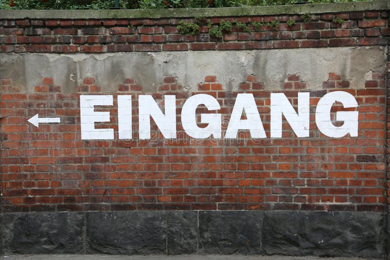 Отправьте СМС EINGANG на кирпичной стене которая значит ВЫХОД в немца стоковое фото Отправьте СМС EINGANG на кирпичной стене которая значит ВЫХОД в немца стоковое фото
