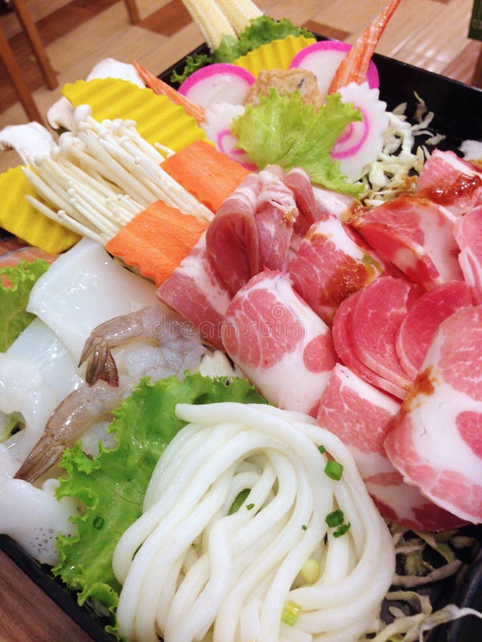 Closed up sliced pork, shrimp, noodle and vegetables for shabu set. Closed up sliced pork, shrimp, noodle and vegetables for shabu set