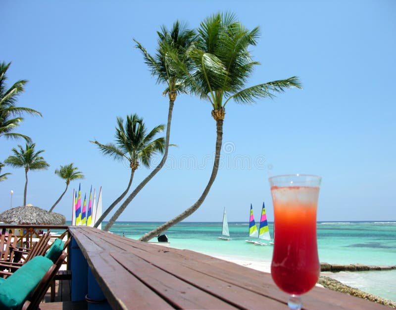 Hotel Club beach with all inclusive cocktail on foreground. Hotel Club beach with all inclusive cocktail on foreground