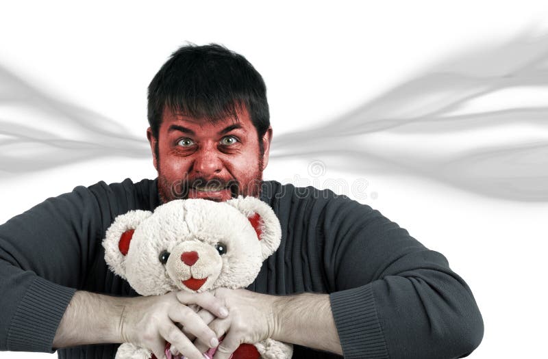 Man strangling teddy bear, anger management, frustration or head exploding concept. Man strangling teddy bear, anger management, frustration or head exploding concept