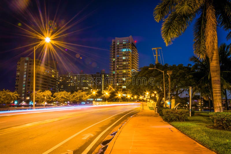 Palm trees and buildings along Dade Boulevard at night, in Miami Beach, Florida. Palm trees and buildings along Dade Boulevard at night, in Miami Beach, Florida