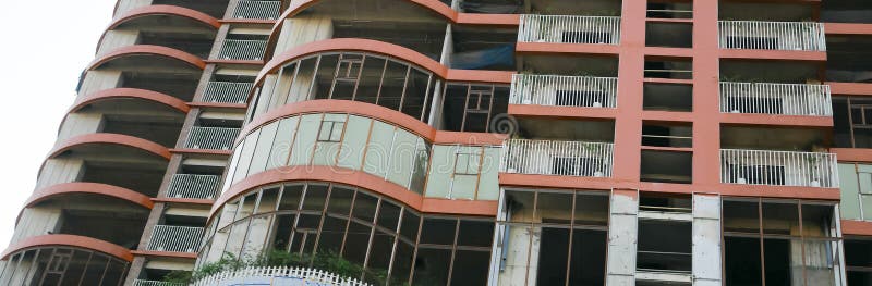 Panorama view multistory unfinished abandoned high-rise residential apartment building construction project downtown suburbs Hanoi, Vietnam, reinforced concrete steel frame no windows. Economic crisis. Panorama view multistory unfinished abandoned high-rise residential apartment building construction project downtown suburbs Hanoi, Vietnam, reinforced concrete steel frame no windows. Economic crisis