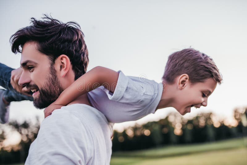 Dad and son having fun outdoors. Dad and son having fun outdoors.