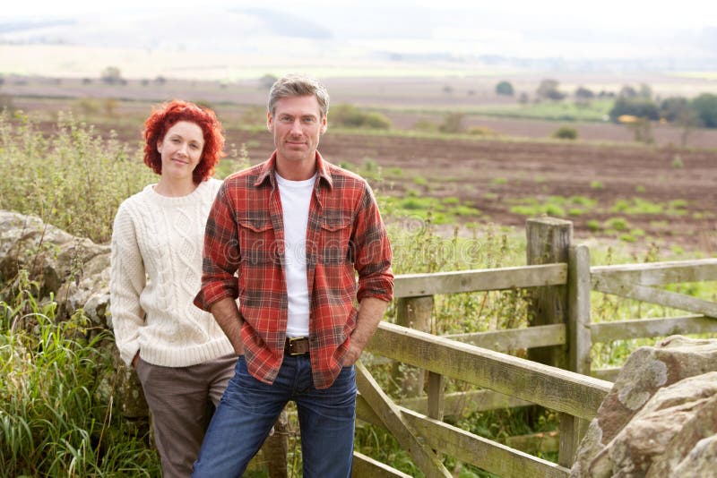 Couple in countryside hands in pockets. Couple in countryside hands in pockets