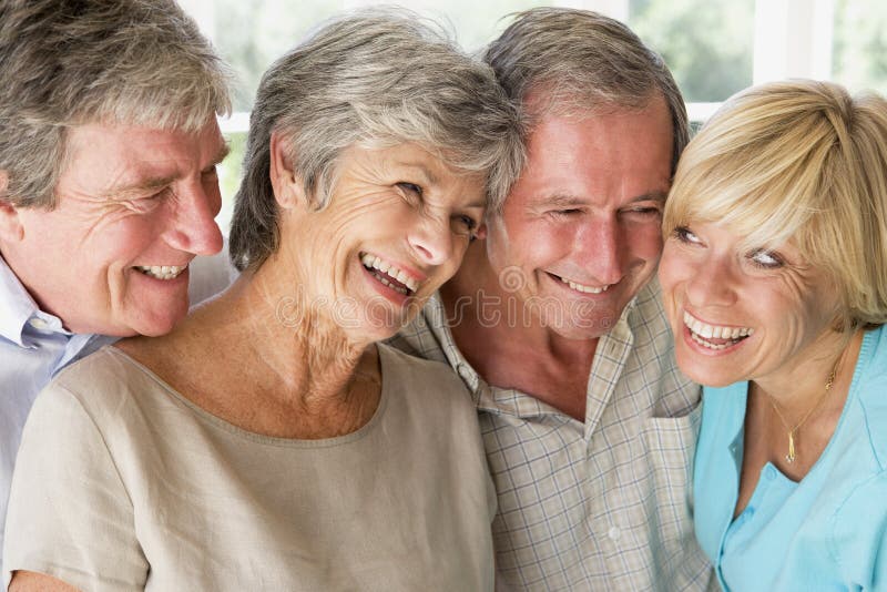 Close up of two couples indoors smiling. Close up of two couples indoors smiling