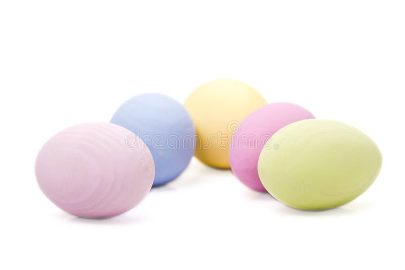 Five pastel colored wooden Easter eggs. Five pastel colored wooden Easter eggs