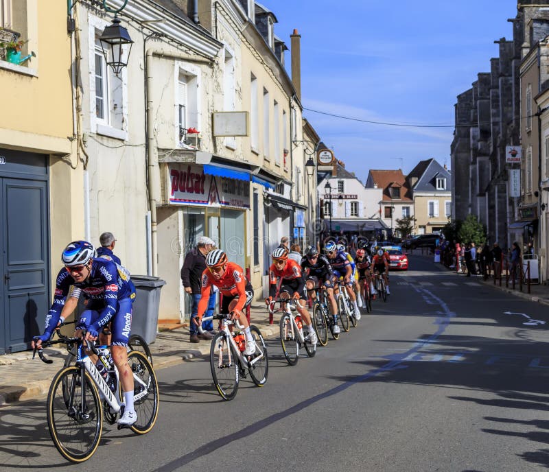 Bonneval, France - October 10, 2021: The peloton riding in Bonneval during road cycling race Paris-Tour 2021. Bonneval, France - October 10, 2021: The peloton riding in Bonneval during road cycling race Paris-Tour 2021