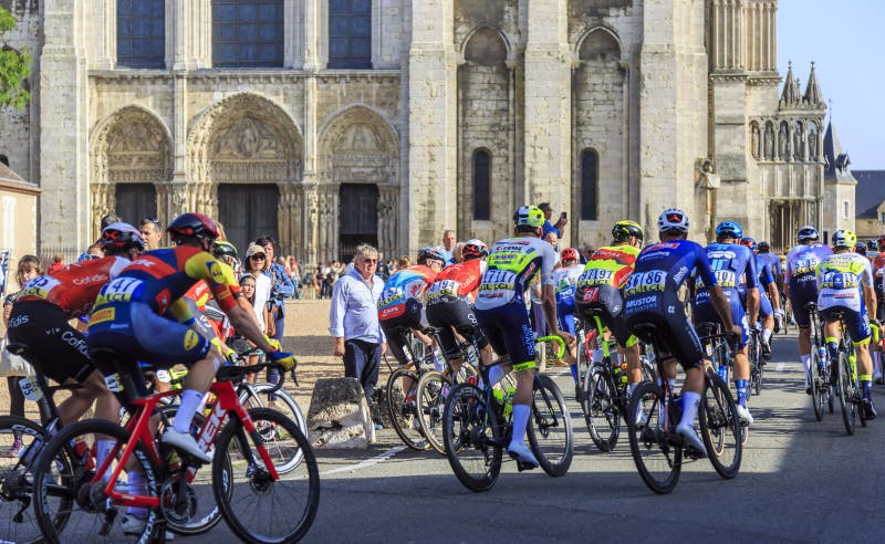 Chartres, France - October 08, 2023: The peloton ride in front of the Chartres Cathedral during the Paris-Tours 2023 road cycling race. Chartres, France - October 08, 2023: The peloton ride in front of the Chartres Cathedral during the Paris-Tours 2023 road cycling race
