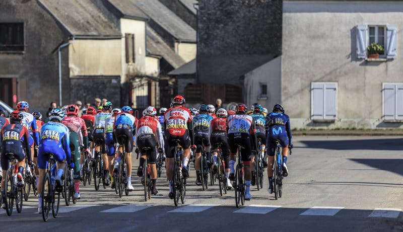 Allainville-en-Beauce, France-March 3rd, 2022: Rear image of the peloton riding during the stage 2 of Paris Nice 2022. Allainville-en-Beauce, France-March 3rd, 2022: Rear image of the peloton riding during the stage 2 of Paris Nice 2022