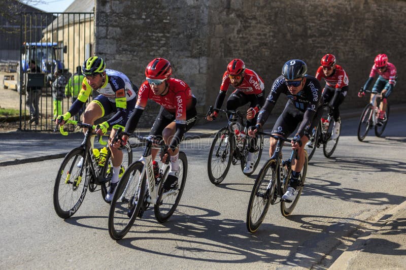 Allainville-en-Beauce, France-March 3rd, 2022: Image of a group of cyclists riding in the peloton during the stage 2 of Paris Nice 2022. Allainville-en-Beauce, France-March 3rd, 2022: Image of a group of cyclists riding in the peloton during the stage 2 of Paris Nice 2022